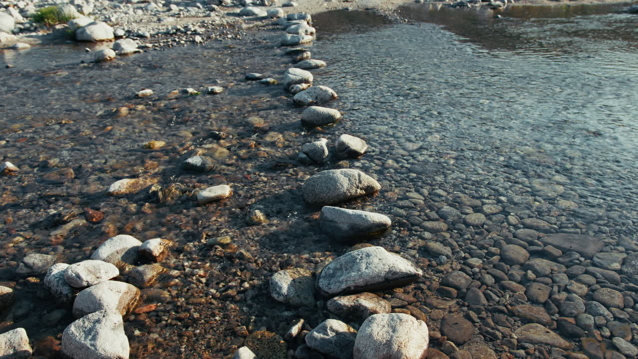 Passage Crossing A River Made With Stone Pebbles Into The Water Flowing