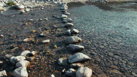 passage crossing a river made with stone pebbles into the water flowing