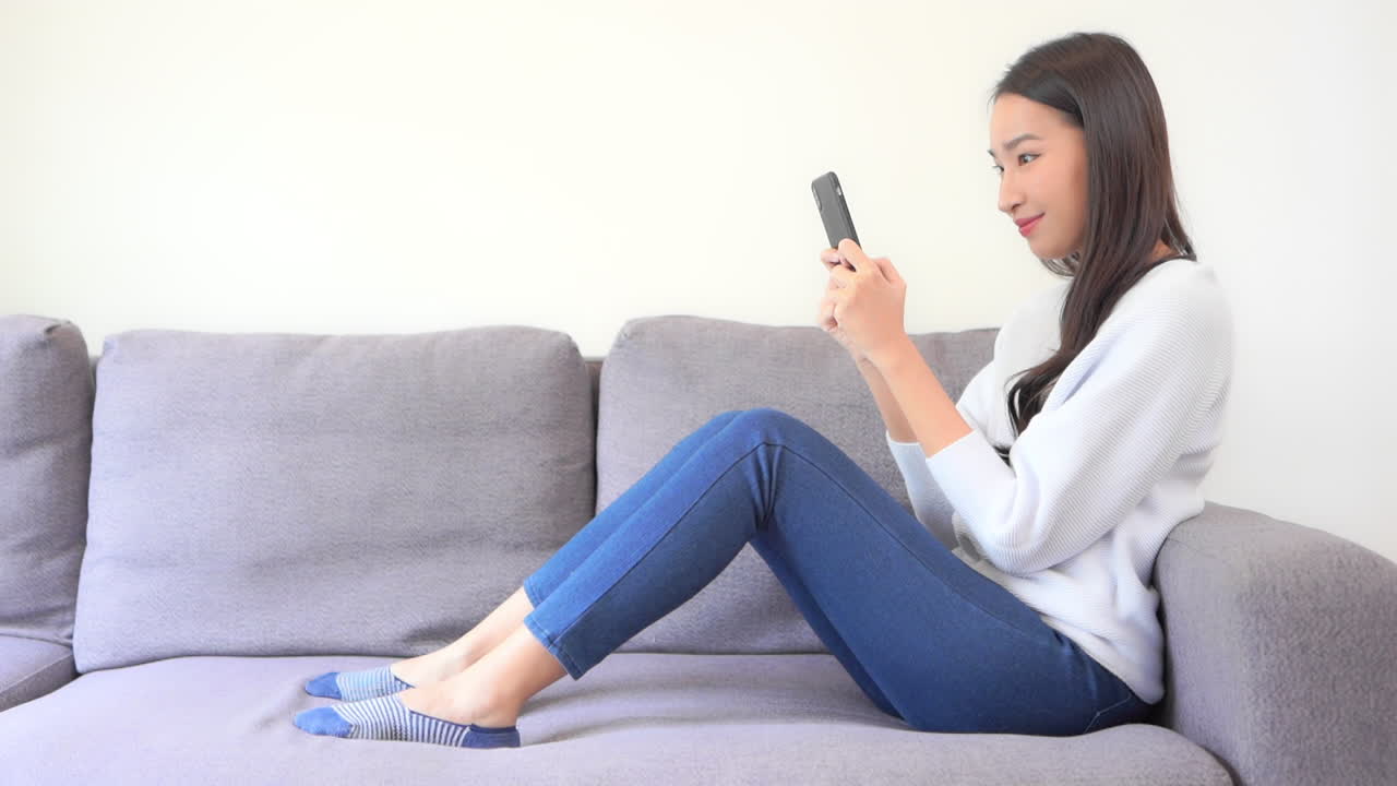 스마트폰에 행복 한 태국 여자 여자 문자 메시지 - 측면 보기