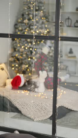 woman relaxing in bed by a christmas tree