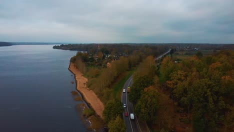 aerial view of colorful forest and trafic road at river daugava in latvia