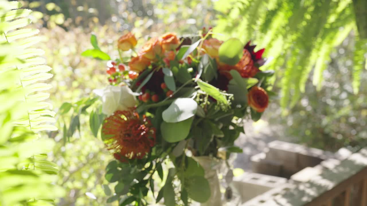 wedding bouquet on wooden deck panning shot