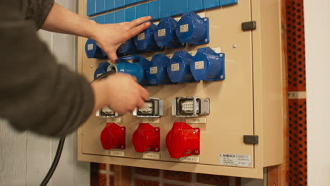 electrical panel with blue 16a and red 32a three phase connectors and distribution box