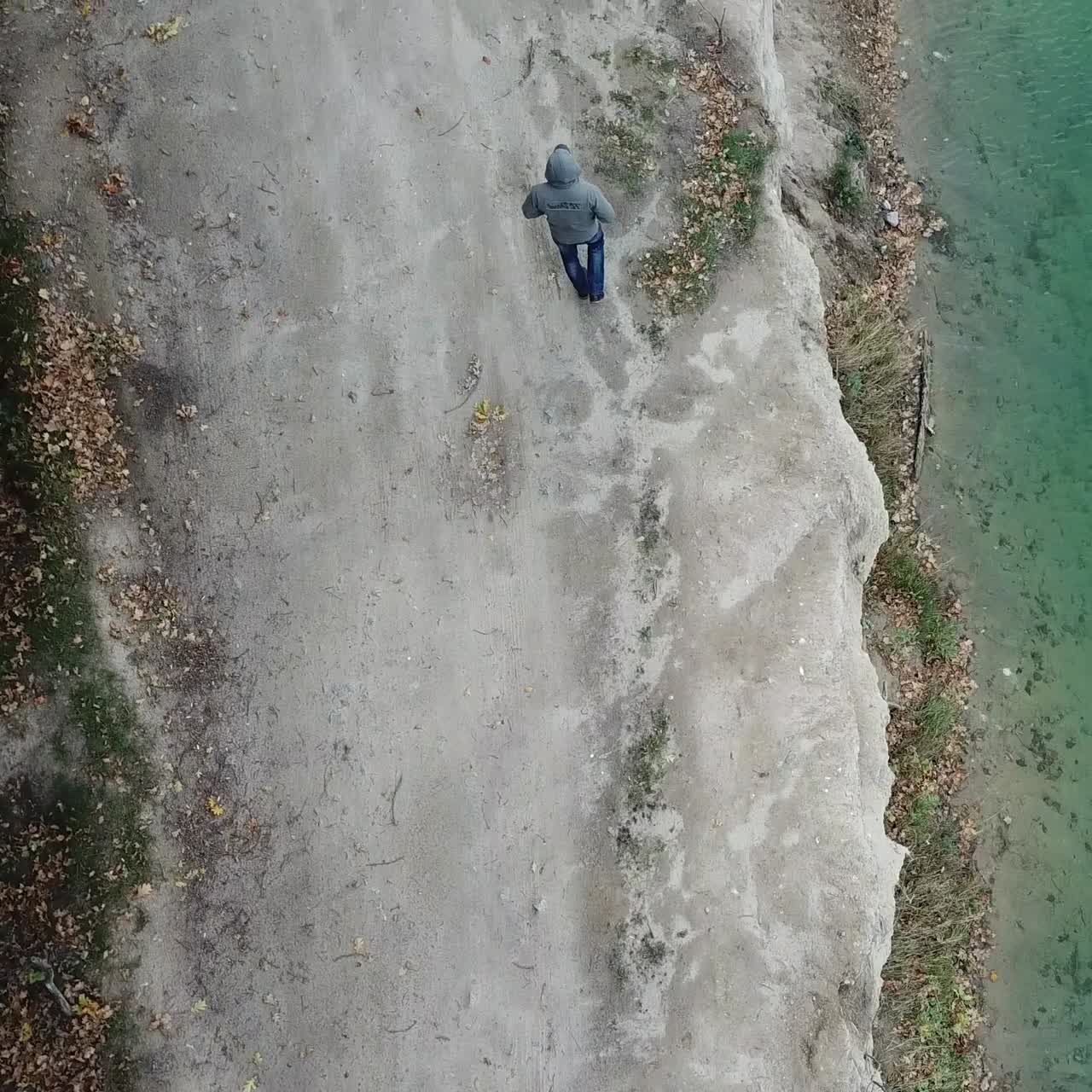 Man walking along lake
