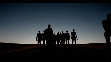 silhouette of a group walking in the desert at dawn or dusk