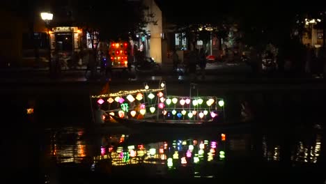 small asian boats passing each other at night