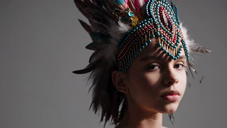girl in an elaborate feather and beaded headdress