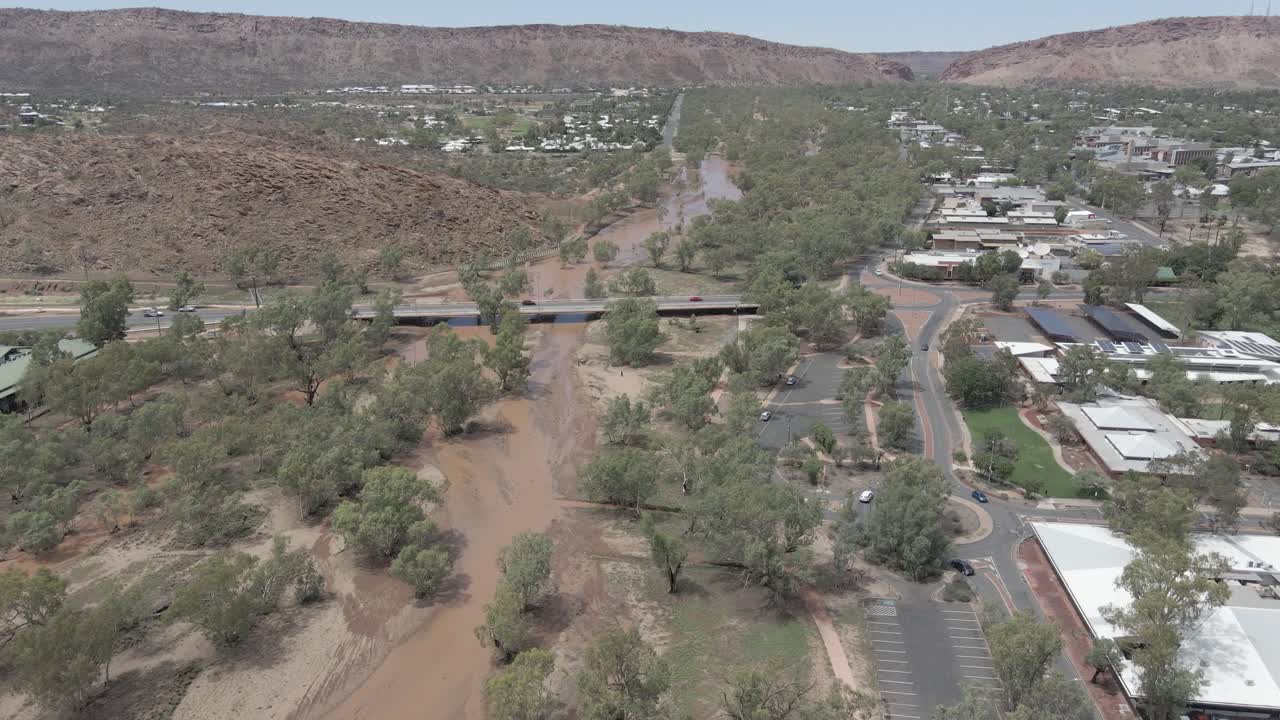 Aerial View Of Todd River With Vehicles Crossing On The Bridge. Ephemeral River In Northern Territory, Australia. sideways shot
