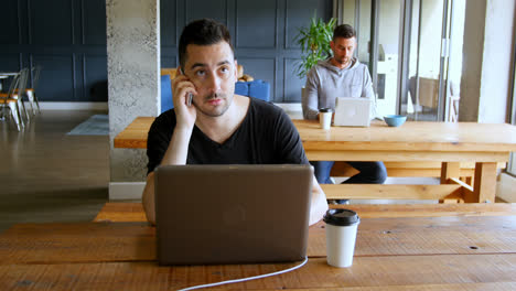 Executives-working-on-table-in-office-cafeteria-4k