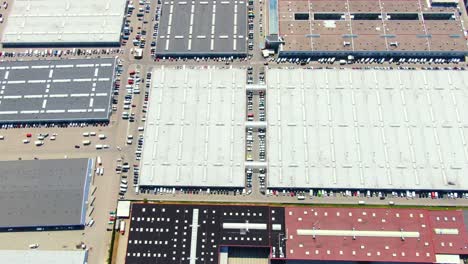 Aerial-footage-of-a-large-shopping-centre-and-car-parks-located-in-the-city