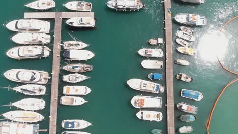 Bird's-eye-view-of-pier-on-Mgarr-Harbour,-overlooking-the-moored-boats,-Gozo-Island-in-Malta