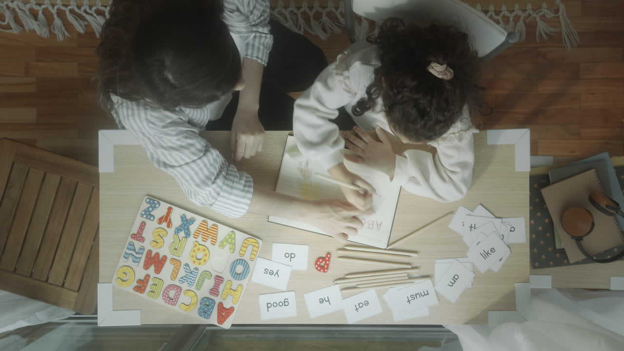 Little Girl Learning Alphabet with Mother at Home