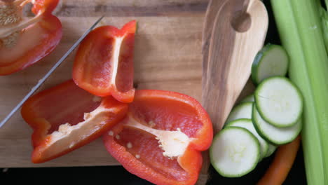 Topview-shot-of-man-cutting-pepper-on-chopping-board