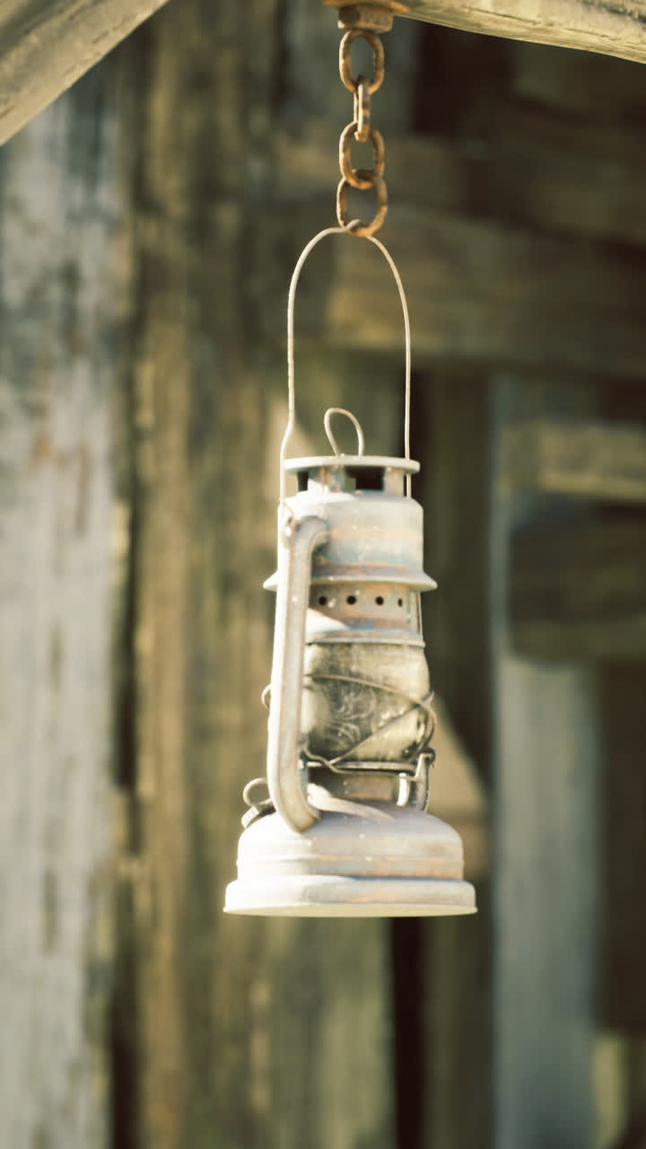 Classic hanging lantern illuminates rustic wooden structure in daylight