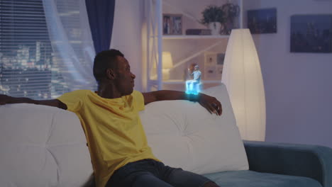 man watching virtual reality experience on a sofa