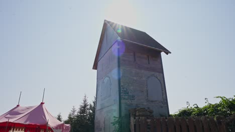 a zoom-in shot toward a small castle where the roof blocks out the sunlight