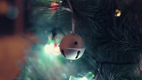 Hanging-Metal-Christmas-Tree-Ball-With-Star-Hole-Design-With-Bokeh-Lights-Background---Closeup-Shot