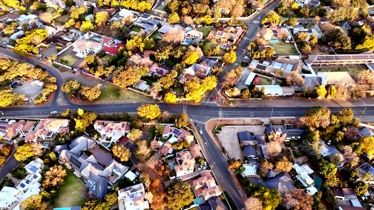 Sunset aerial over Randburg residential neighborhood with trees in autumn colors