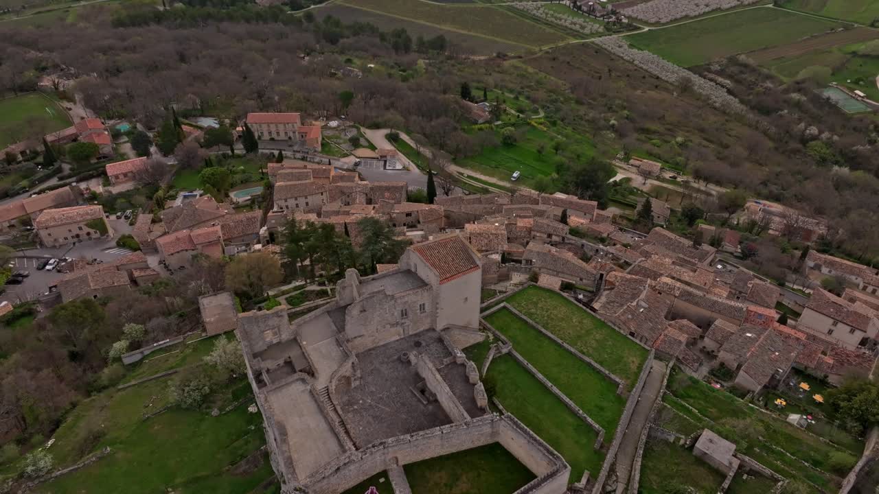 Vista aerea delle rovine del castello e del villaggio di Lacoste all'ora d'oro, in Provenza