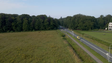 Dolly-of-busy-street-running-through-rural-Holland