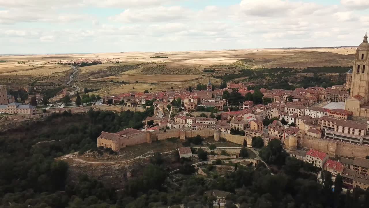 Segovia Cathedral stands tall and majestic, dominating the cityscape of Segovia's historic center, surrounded by traditional architecture and the vast Castilian landscape , drone establishing shot