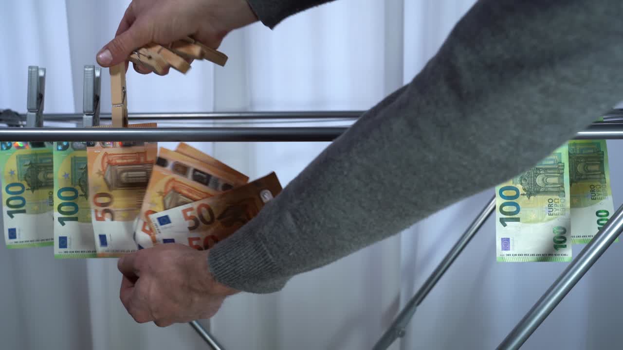 money hanging to dry with clothespin - Euro money banknotes after  washing machine - illegal cash 50, 100 €  and mafia money laundering - increase in the cost of living, energy and gas