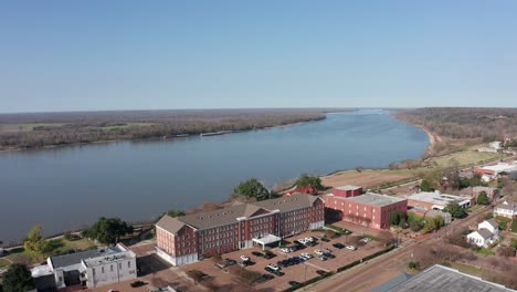 aerial descending shot of the grand natchez hotel along the mississippi river in natchez, mississippi