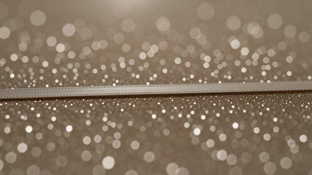 Reacting to overhead light shift, textured strip staying steady in studio, glittery bokeh shifting