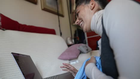 woman cleaning a laptop on a couch