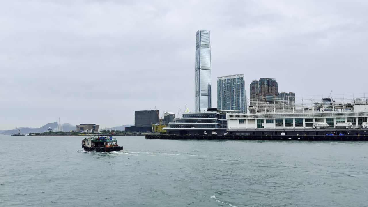 Footage captured from a ferry in Hong Kong, showcasing the city skyline, bustling harbor, moving vessels, and waterfront activity, highlighting the dynamic energy and scenic beauty of Victoria Harbour