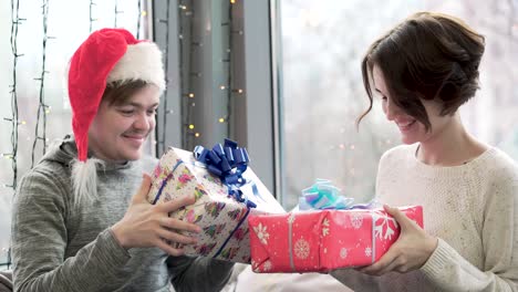 couple exchanging christmas presents