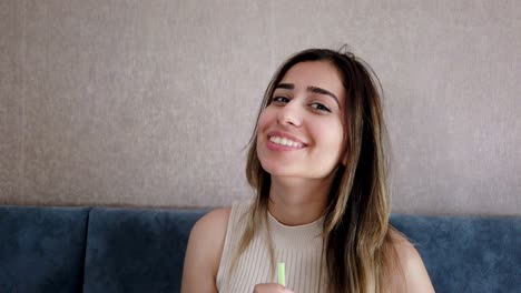 Slow-motion:Beautiful-young-girl-drinks-coke-or-soda-with-a-big-enjoy-in-a-restaurant-or-cafe