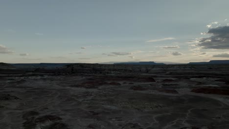 Pullback-aerial-reveal-of-a-barren-desert-wasteland-at-dusk