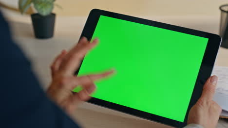 manager finger touching greenscreen tab at office closeup. woman working device