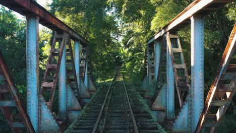 old rusted train brigde construction over the river revealing shot