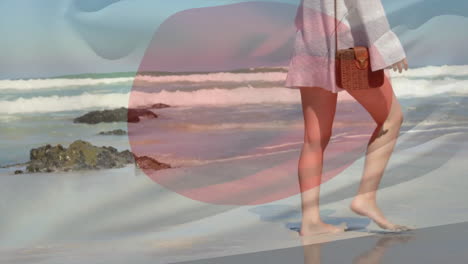 animación de la bandera de japón sobre caucásicos caminando descalzos y bailando en la playa soleada