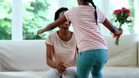 Mother-and-daughter-embracing-each-other-in-living-room