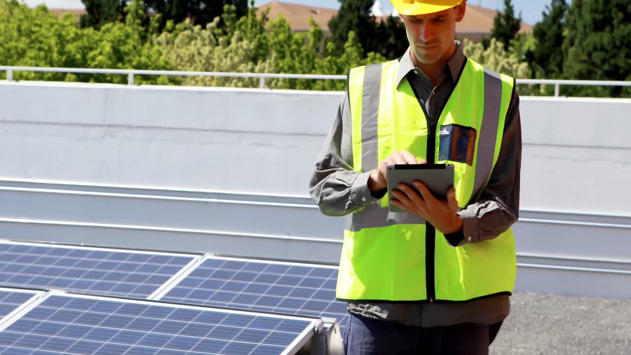 Male worker using digital tablet at solar station 4k