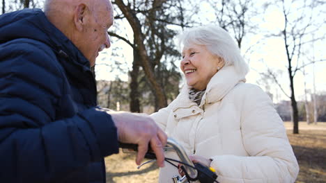 close-up view of a senior couple talking and laughing in the park on a winter day