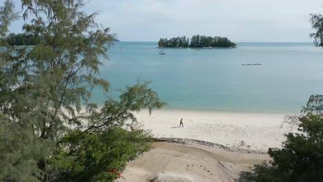 Luftaufnahme-Vom-Wald-Zum-Strand,-Enthüllt-Die-Insel-Seratos-Am-Strand-Von-Pantai-Kok