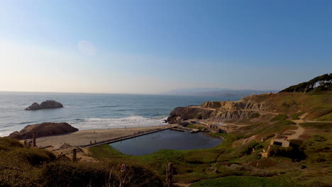 Still-shot-of-the-Sutro-Baths-and-the-Pacific-Coastline-in-San-Francisco,-California-on-a-beautiful,-calm-summer-evening-with-sunset-approaching---4K