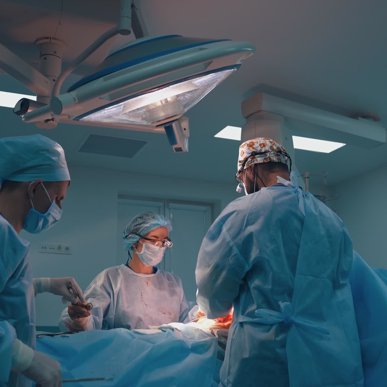 Abdominoplasty of the abdomen. Abdominal liposuction. Partial removal of fat and mucous tissues of the abdomen. The doctor cuts a laser surgical scalpel.