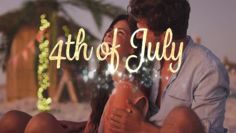 independence day text and spots of light against caucasian couple embracing each other at the beach