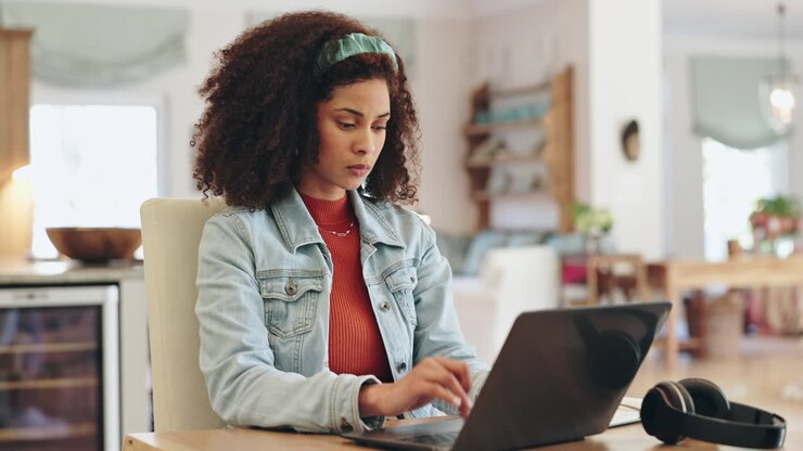 Woman working on a laptop at home