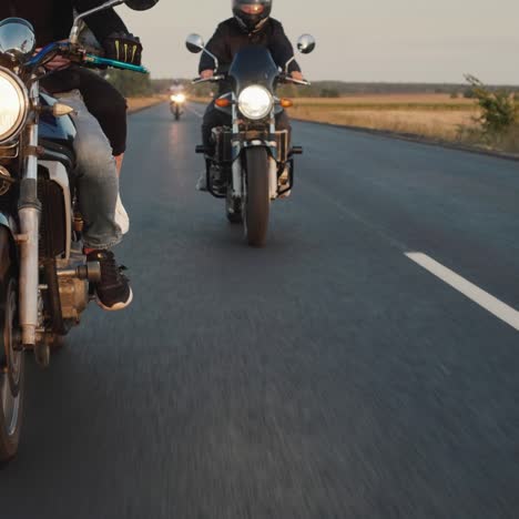 a group of bikers rides along the highway in a row 3