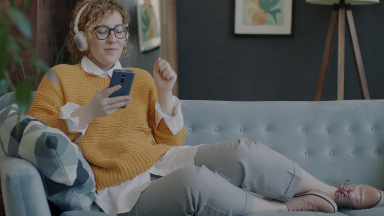 Woman Enjoying Music on Couch