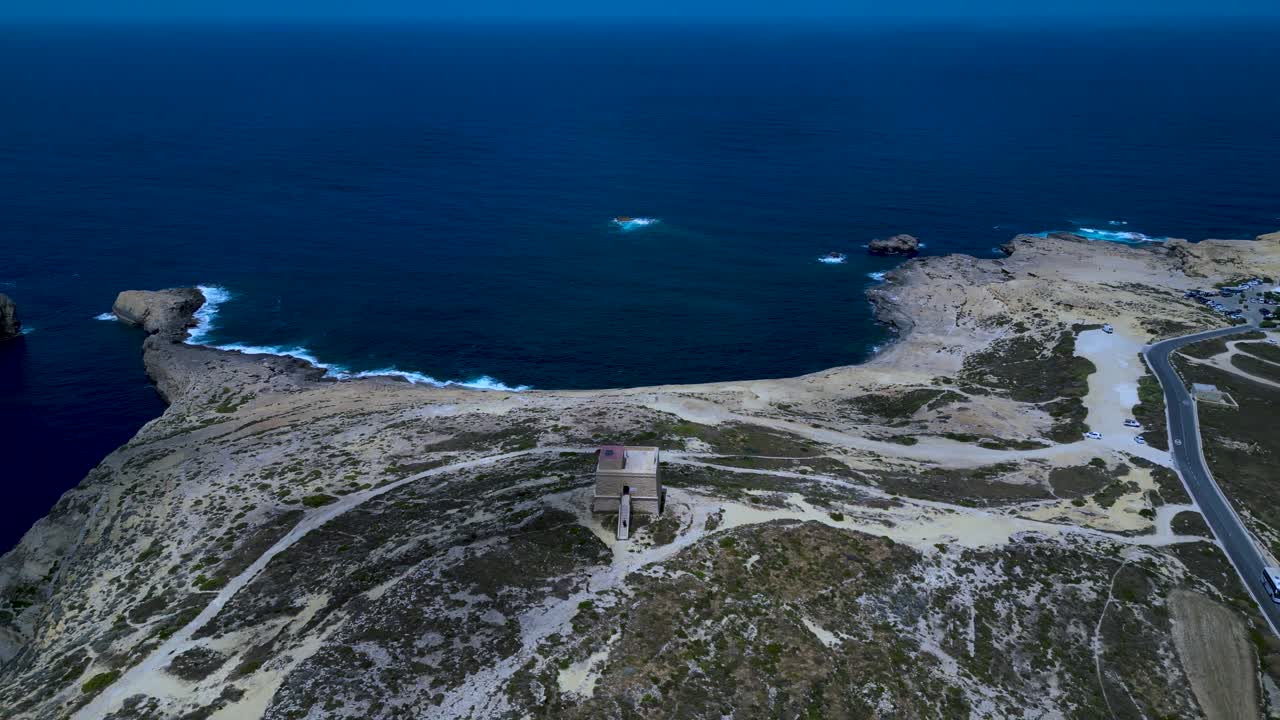 Dwejra Tower, Malta, and surrounding coastline, orbiting wide angle aerial view