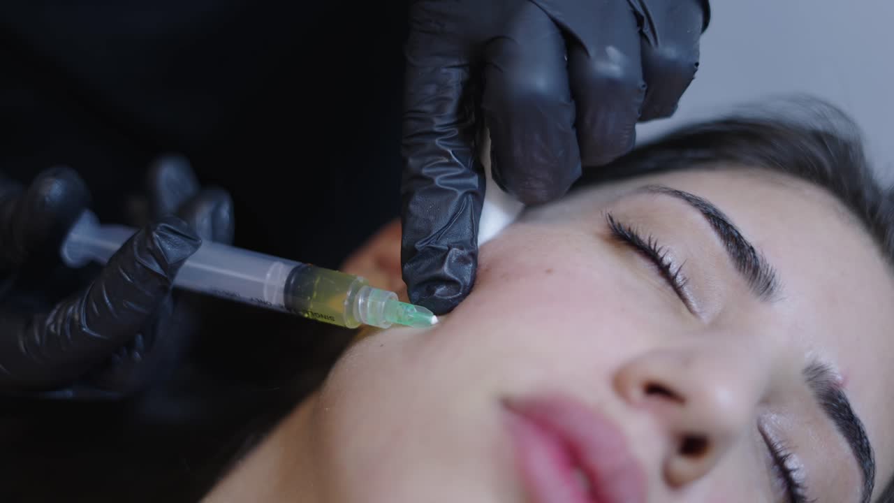 Woman Undergoing a Facial Cosmetic Injection Procedure