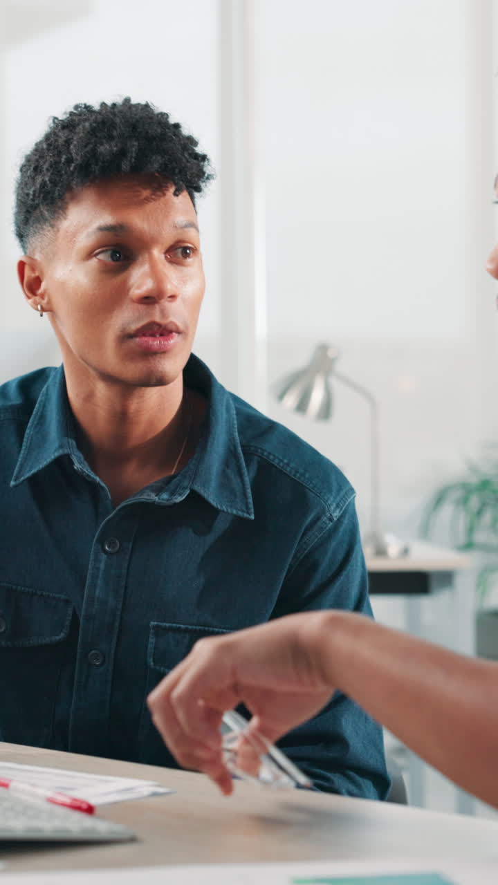 Two Young Men Discussing Business Ideas in a Modern Office