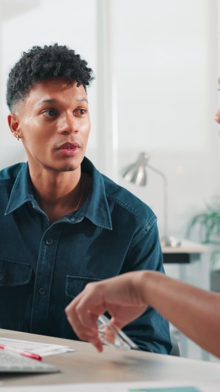 Two Young Men Discussing Business Ideas in a Modern Office